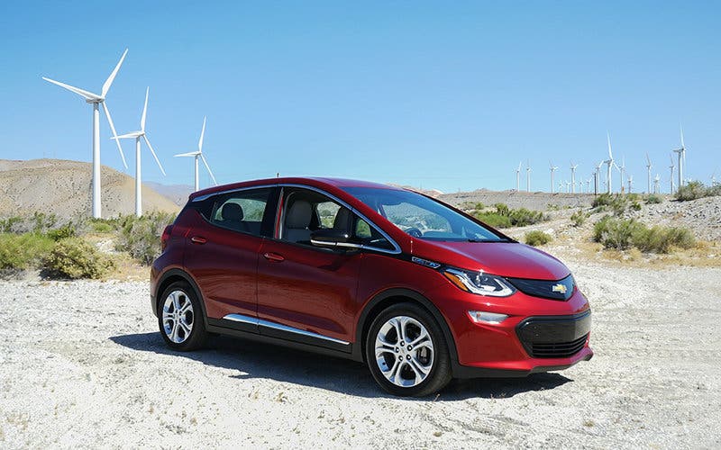 Music festival goers stop for a photo opp with their Bolt EV at iconic Indio, California stops.