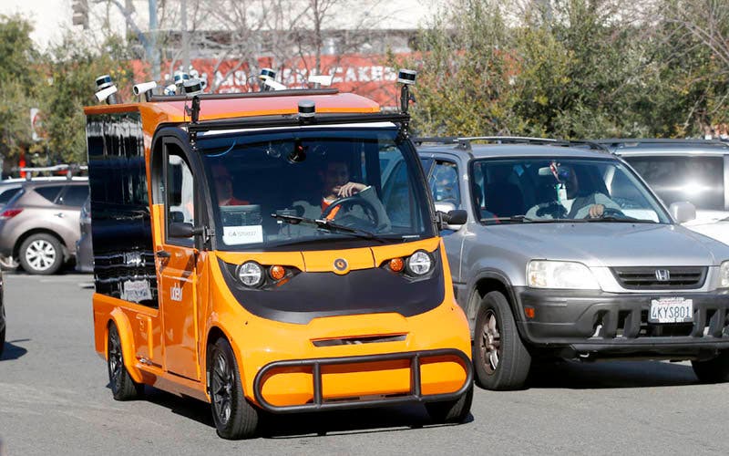 Udelv's autonomous delivery vehicle (with human backup driver in case of emergency) drives back to Draeger's market in San Mateo, Calif., Tuesday, Jan. 30, 2017, after making its initial grocery deliveries. (Karl Mondon/Bay Area News Group)