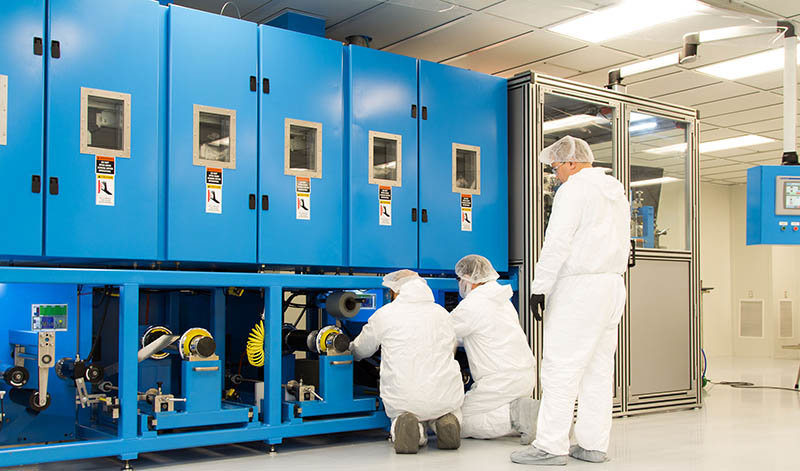 Workers examine a coater, equipment used in development of solid-state battery cells at Solid Power's pilot-production facility in Louisville, Colorado in December 2018.Solid Power Inc.
