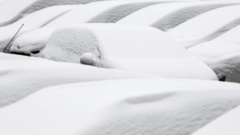 Snow-covered cars are parked in Freiburg, southern Germany, Sunday, March 18, 2018.(Patrick Seeger/dpa via AP)