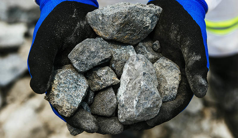 A worker holds rocks of raw platinum ore for a photograph at the Northam Platinum Ltd. Booysendal platinum mine, located outside the town of Lydenburg in Mpumalanga, South Africa, on Tuesday, Jan. 23, 2018. Booysendal will use a system developed by an Austrian company that builds ski lifts to transport the ore up a 30 degree incline out of a valley for processing, instead of the traditional conveyer used throughout South Africa or the more expensive option of trucking. Photographer: Waldo Swiegers/Bloomberg via Getty Images